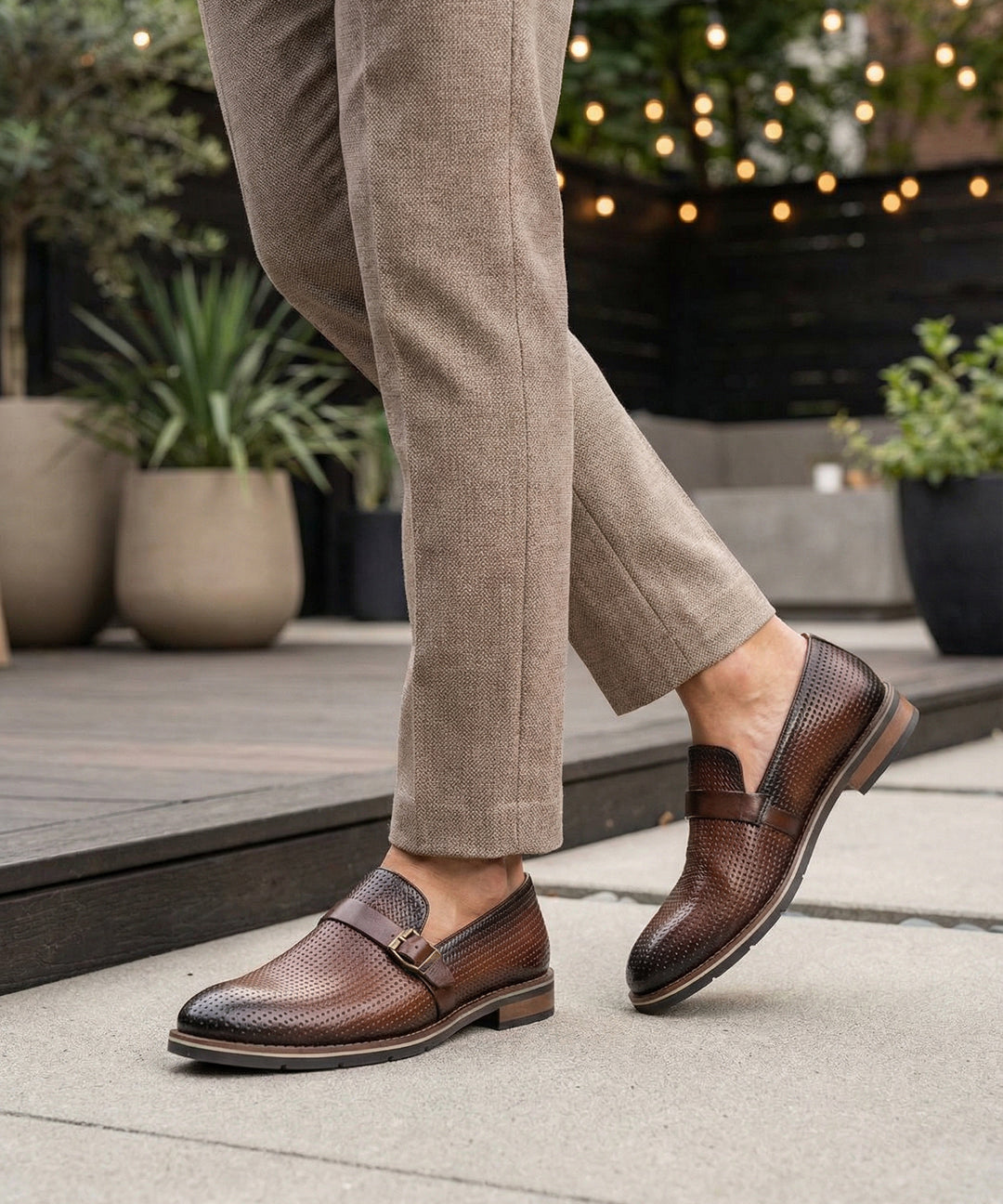 bugatti Laziano Revo Comfort premium brown leather penny loafers with decorative perforations and buckle.
