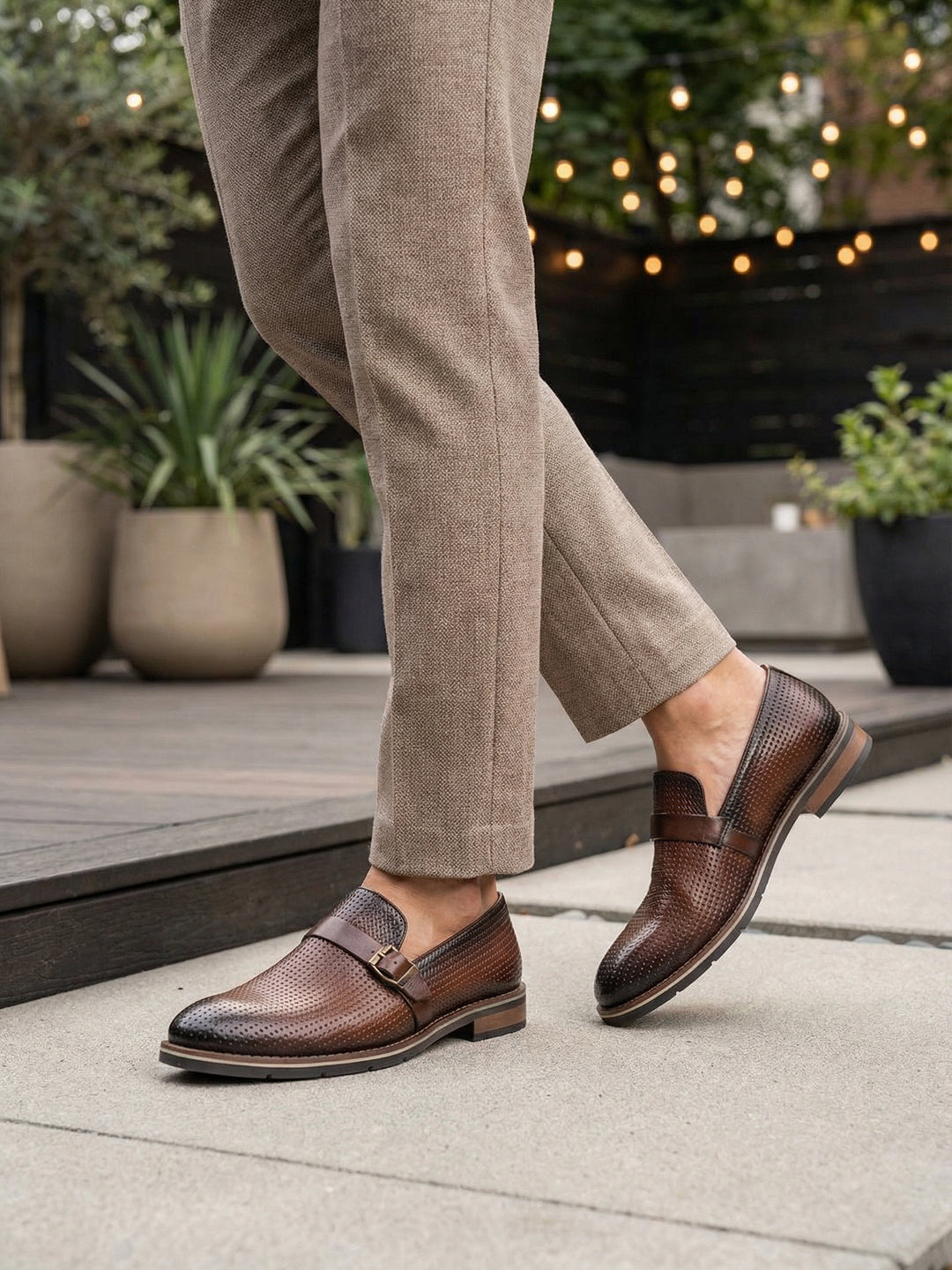 bugatti Laziano Revo Comfort premium brown leather penny loafers with decorative perforations and buckle.
