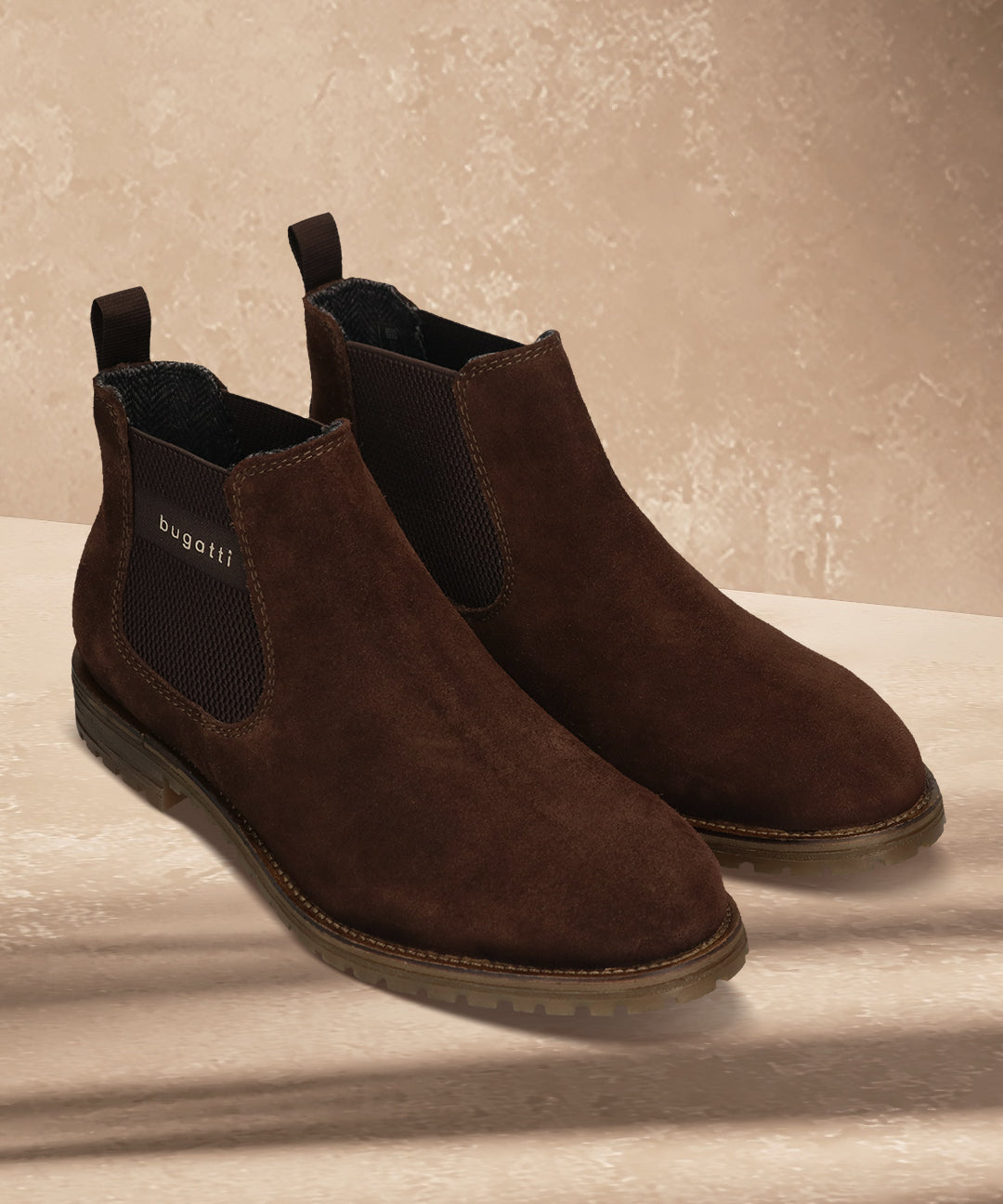 A brown Men's bugatti Chelsea Boots featuring a round toe plain toe, moulded  heel, and a wide fit. Made from premium genuine leather with a durable tr outsole, this elastic design offers both style and comfort.