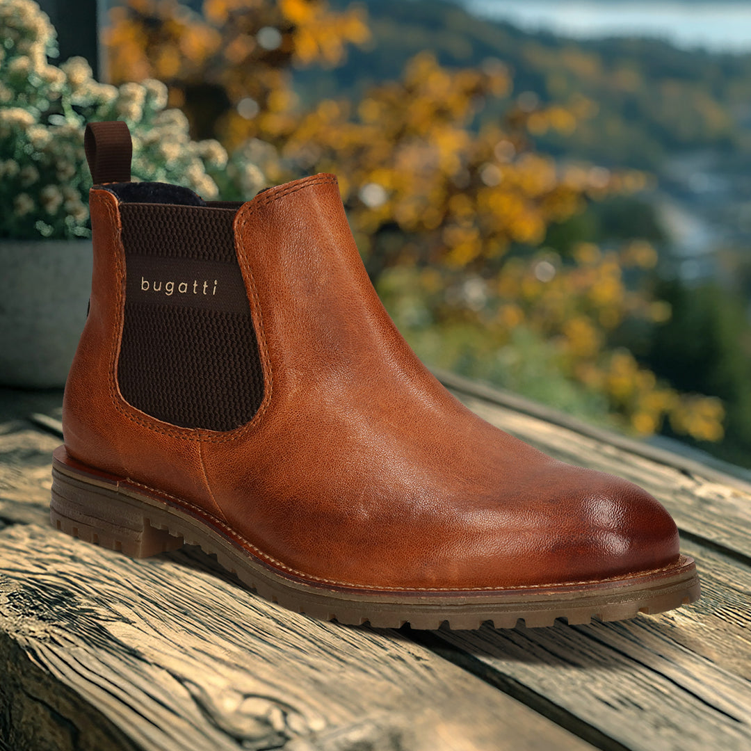 A cognac Men's bugatti Chelsea Boots featuring a round toe plain toe, moulded  heel, and a wide fit. Made from premium genuine leather with a durable tr outsole, this elastic design offers both style and comfort.