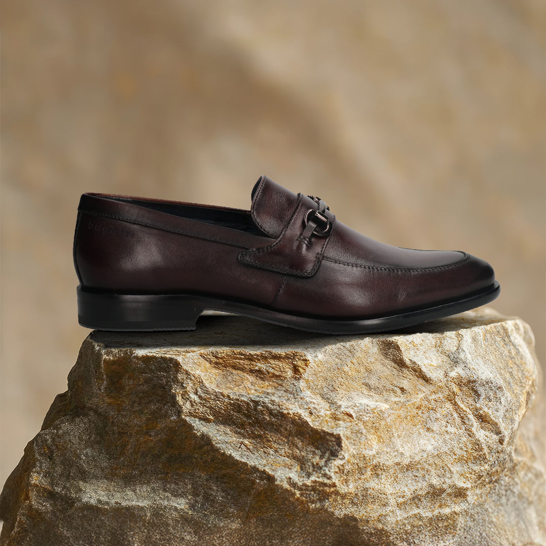 A grey Men's bugatti Bit Loafer featuring a round toe apron toe, stacked heel. Made from premium genuine leather with a durable leather outsole, this slip-on design offers both style and comfort.