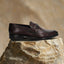 A grey Men's bugatti Bit Loafer featuring a round toe apron toe, stacked heel. Made from premium genuine leather with a durable leather outsole, this slip-on design offers both style and comfort.