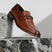 A cognac Men's bugatti Bit Loafer featuring a round toe apron toe, stacked heel. Made from premium genuine leather with a durable leather outsole, this slip-on design offers both style and comfort.