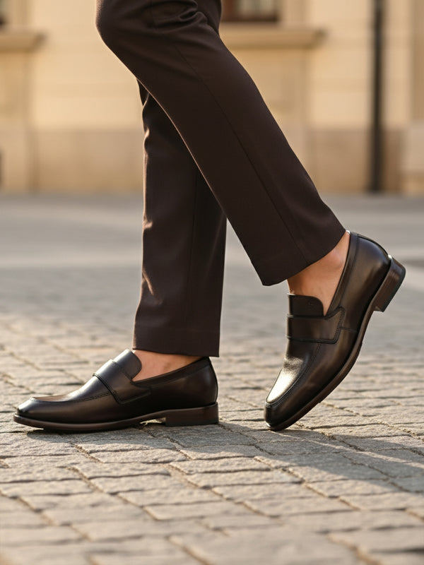 Bugatti Mansueto Flex Revo dark brown leather slip-on shoe, worn with dark brown dress pants.
