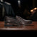 A brown Men's bugatti Penny Loafer featuring a round toe apron toe, stacked heel. Made from premium genuine leather with a durable leather outsole, this slip-on design offers both style and comfort.