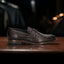 A brown Men's bugatti Penny Loafer featuring a round toe apron toe, stacked heel. Made from premium genuine leather with a durable leather outsole, this slip-on design offers both style and comfort.