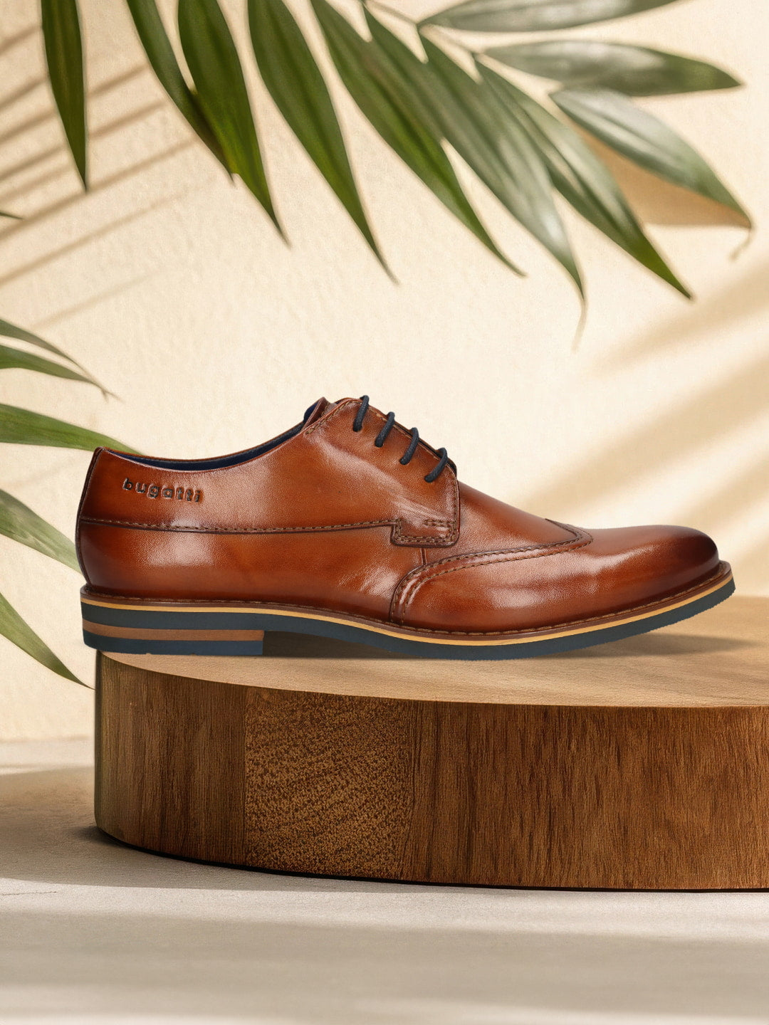 Men's Bugatti derby cognac leather shoes with a round toe and wing tip featuring a stacked heel , a eva outsole , and laces fastening.