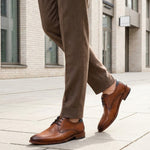 bugatti Lark Flex cognac leather derby shoe with dark laces, worn with brown trousers.
