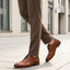bugatti Lark Flex cognac leather derby shoe with dark laces, worn with brown trousers.
