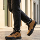 Lifestyle view of bugatti Columb Cognac Comfort Sneakers, with dark trousers and light-colored building in the background.
