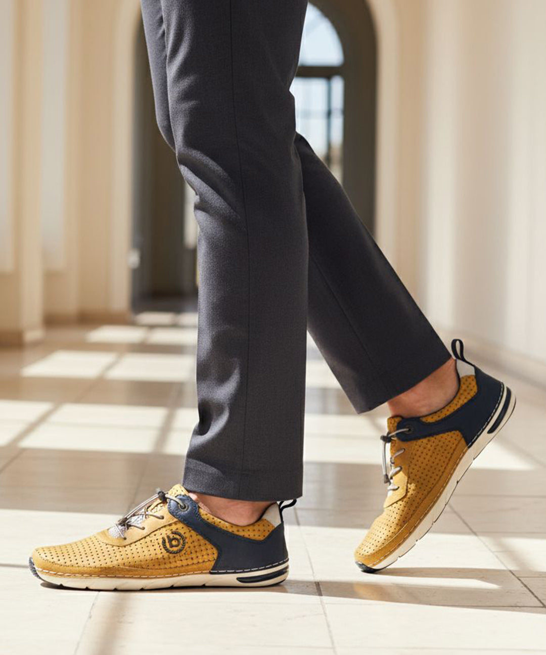 Lifestyle shot of bugatti Glenans yellow Comfort Sneakers featuring a perforated upper and navy accent.
