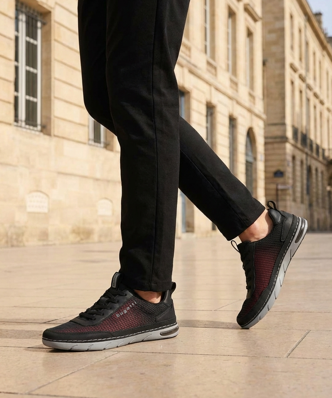 Lifestyle cropped shot of bugatti Glenans black comfort sneakers featuring a breathable upper, laces, and grey sole.
