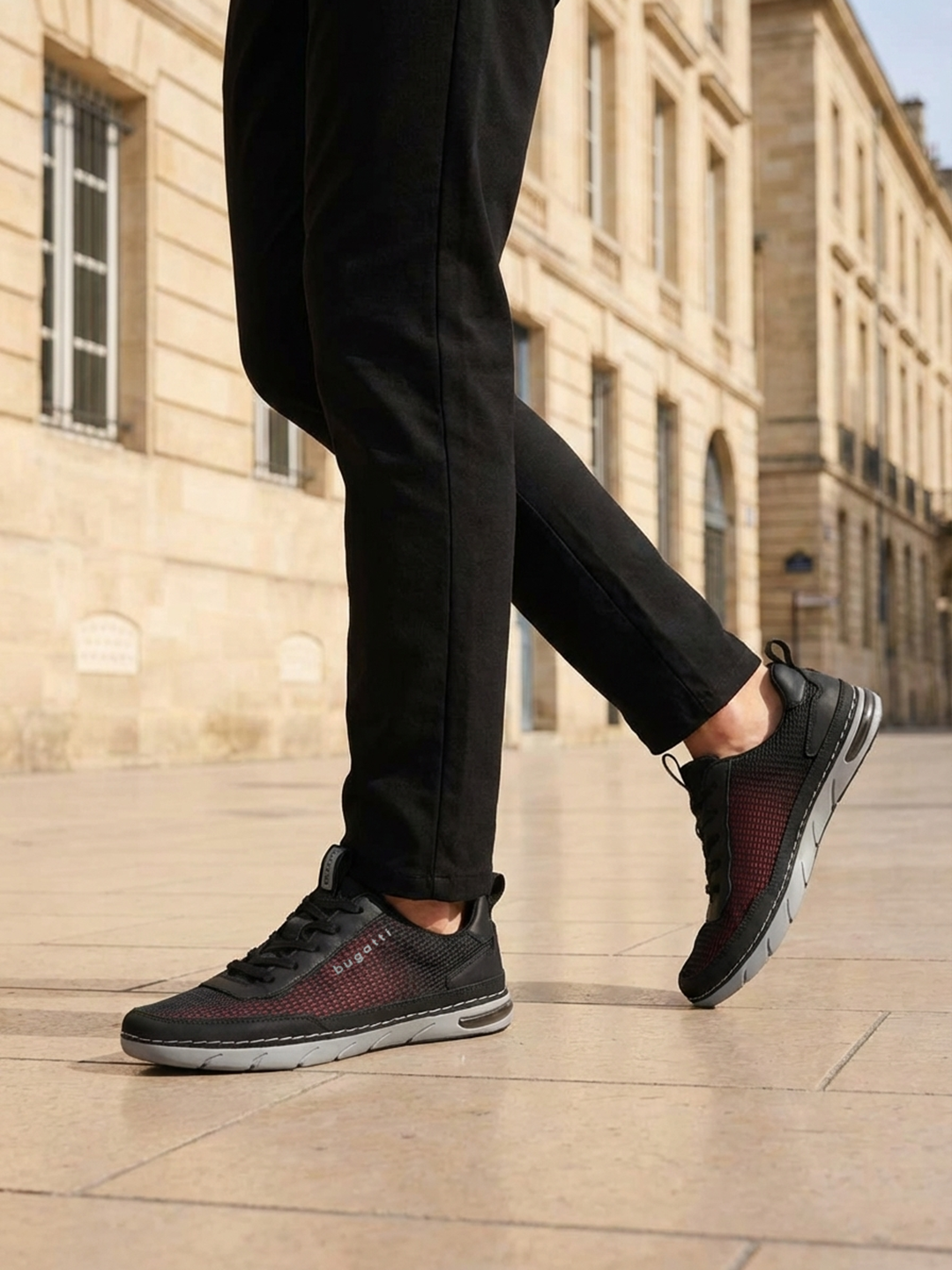 Lifestyle cropped shot of bugatti Glenans black comfort sneakers featuring a breathable upper, laces, and grey sole.
