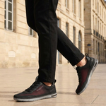 Lifestyle cropped shot of bugatti Glenans black comfort sneakers featuring a breathable upper, laces, and grey sole.
