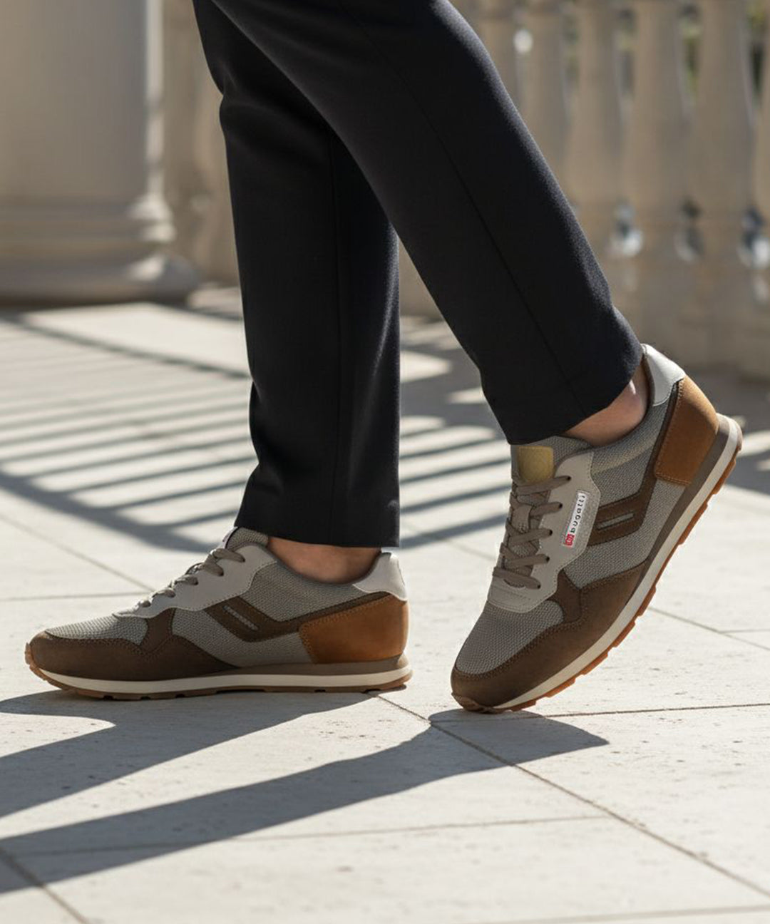 Lifestyle view of bugatti Sacramento brown comfort sneakers featuring a brown suede and gray textile design.
