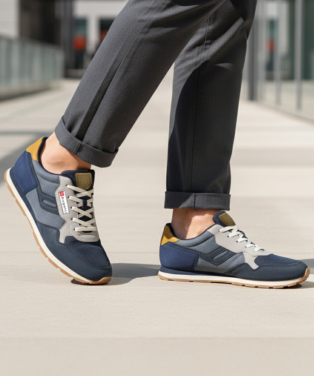 Lifestyle shot of bugatti Sacramento comfort sneakers in navy and gray with a tan accent.