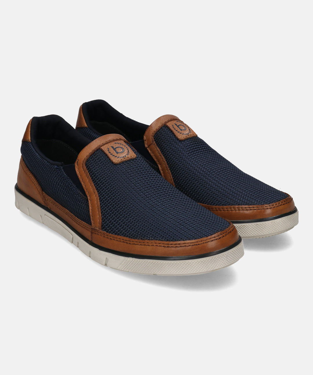 Dark blue casual slip-on shoes by bugatti with brown leather details and white soles.