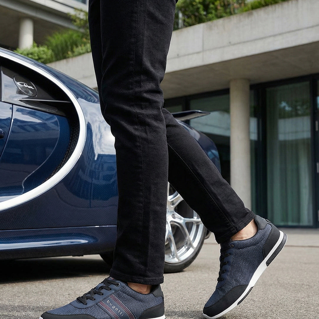 Lifestyle shot of bugatti "Report ECO" dark blue sneakers, with a textured upper, black accents, and a white sole.
