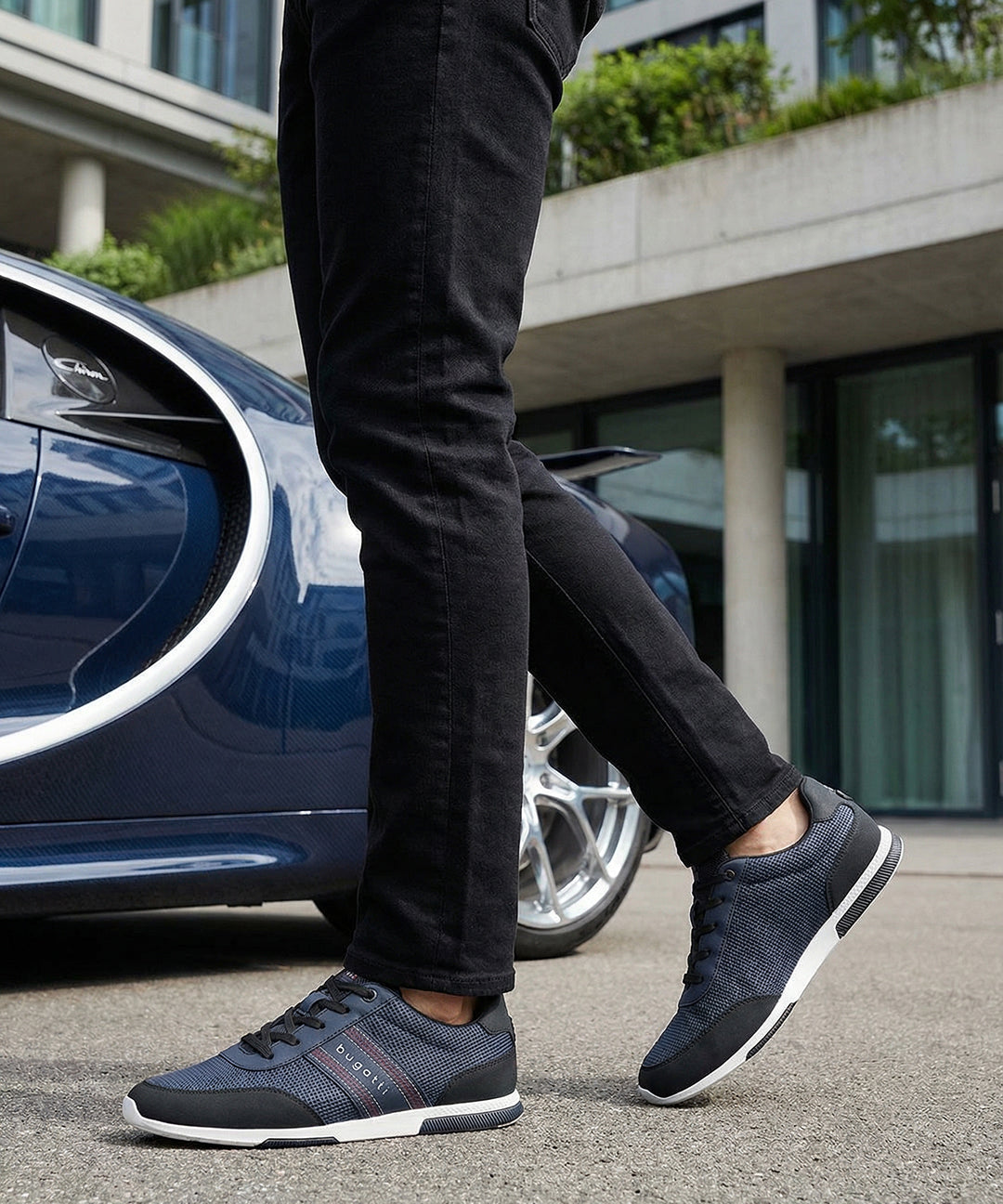 Lifestyle shot of bugatti "Report ECO" dark blue sneakers, with a textured upper, black accents, and a white sole.

