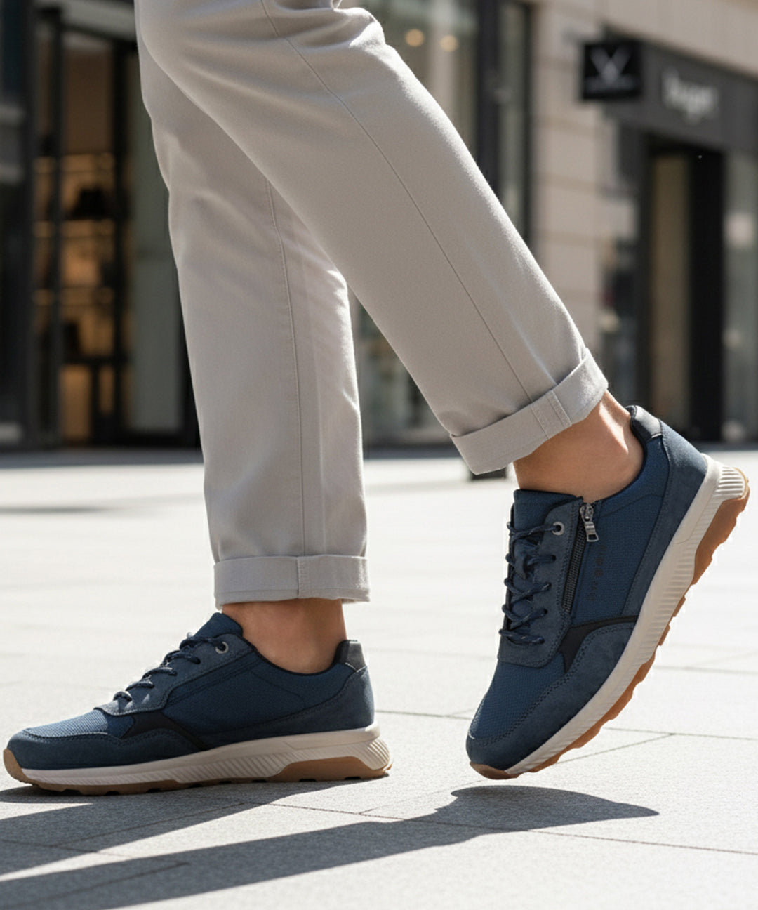 Lifestyle view of bugatti Jerit dark blue comfort sneakers with laces and a side zipper.
