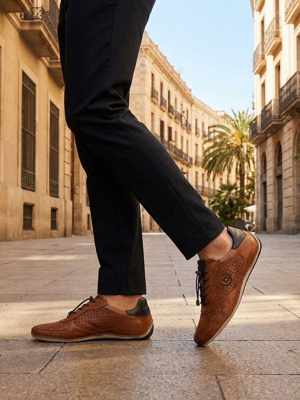 Lifestyle shot of bugatti Canario Cognac Premium Leather Comfort Sneakers worn with black trousers on a city street.