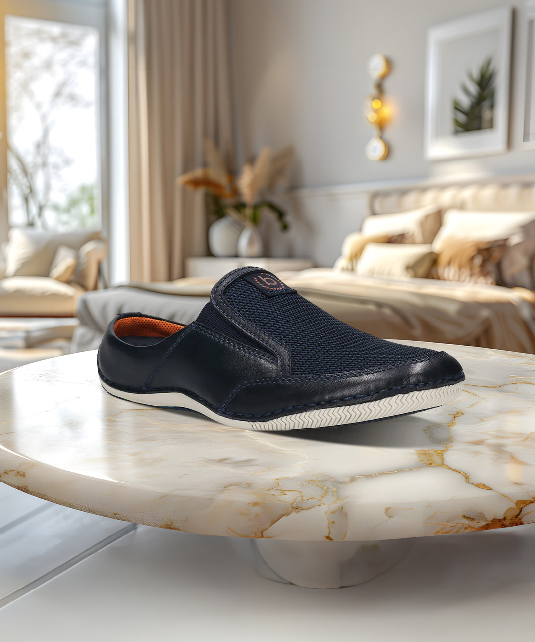 A blue Men's bugatti Mules featuring a round toe plain toe, zero heels heel. Made from premium genuine leather with a durable sebs (block copolymer) outsole, this slip-on design offers both style and comfort.