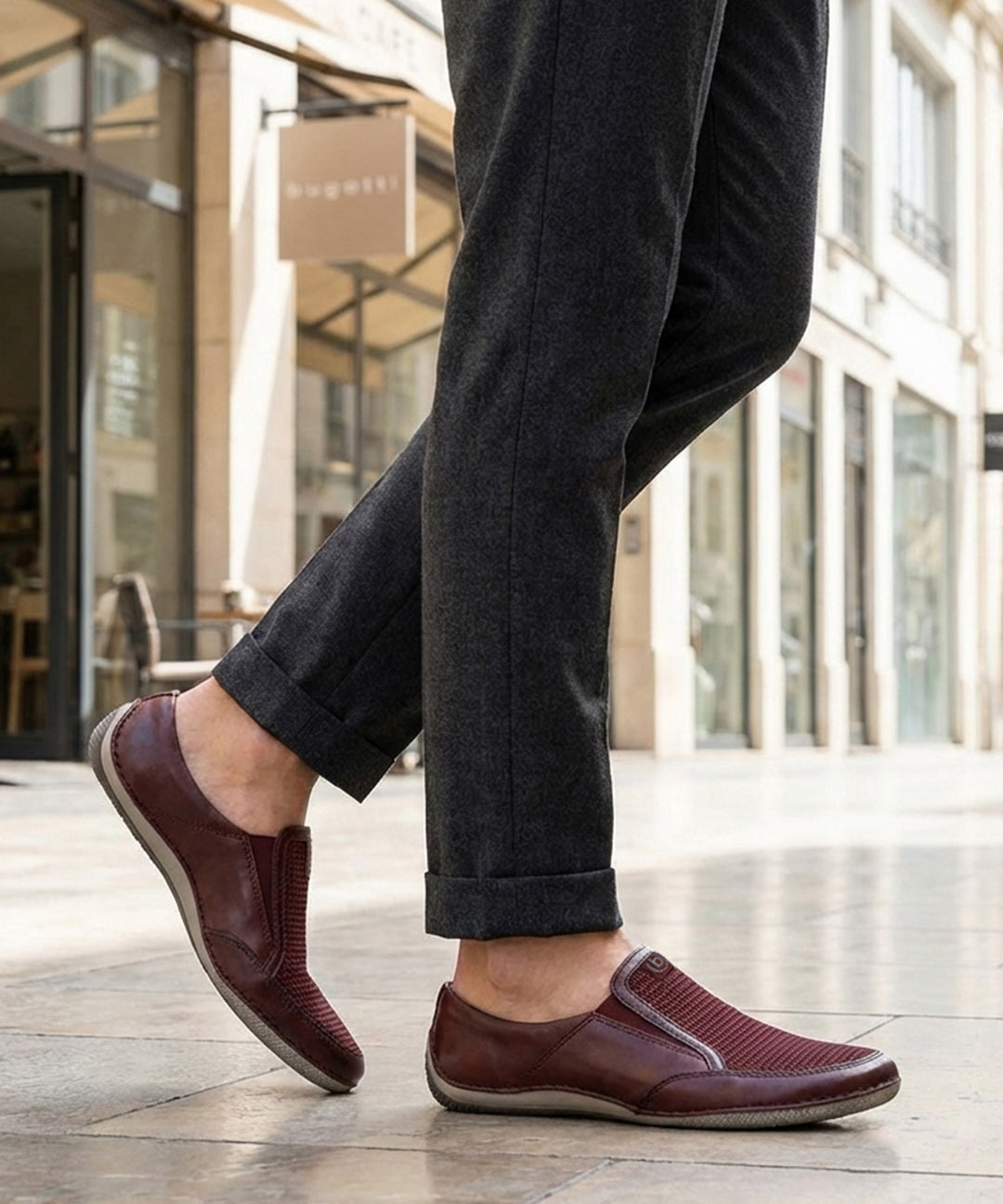 Lifestyle shot of bugatti Canario slip-on shoes in dark red premium leather with mesh detail.
