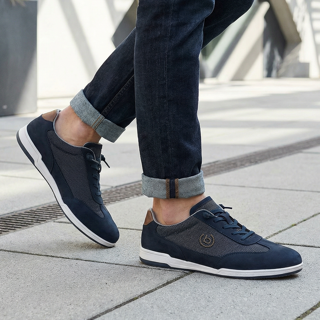 Lifestyle shot of bugatti SOLAR EXKO dark blue sneakers, featuring premium leather, suede and mesh upper, and white soles.
