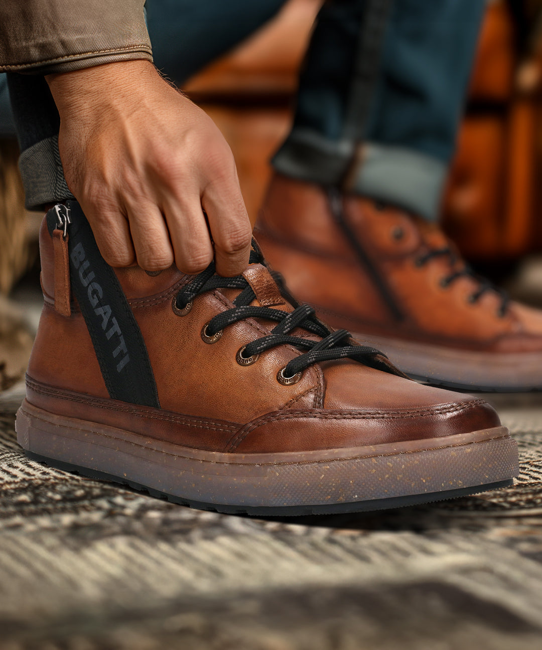 A cognac Men's bugatti Casual Boots featuring a round toe plain toe, zero heels heel, and a wide fit. Made from premium genuine leather with a durable tr outsole, this zipper design offers both style and comfort.