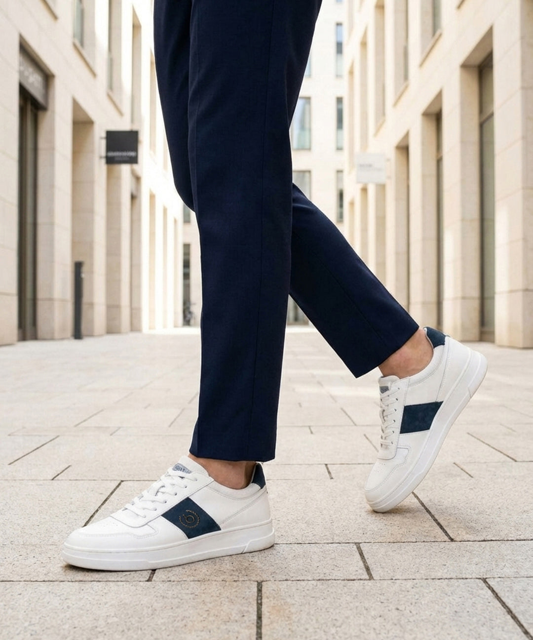 Lifestyle view of bugatti Franc off-white sneakers in premium leather with a navy stripe and white laces.