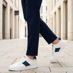 Lifestyle view of bugatti Franc off-white sneakers in premium leather with a navy stripe and white laces.