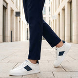 Lifestyle view of bugatti Franc off-white sneakers in premium leather with a navy stripe and white laces.