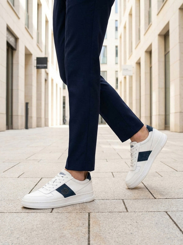 Lifestyle view of bugatti Franc off-white sneakers in premium leather with a navy stripe and white laces.