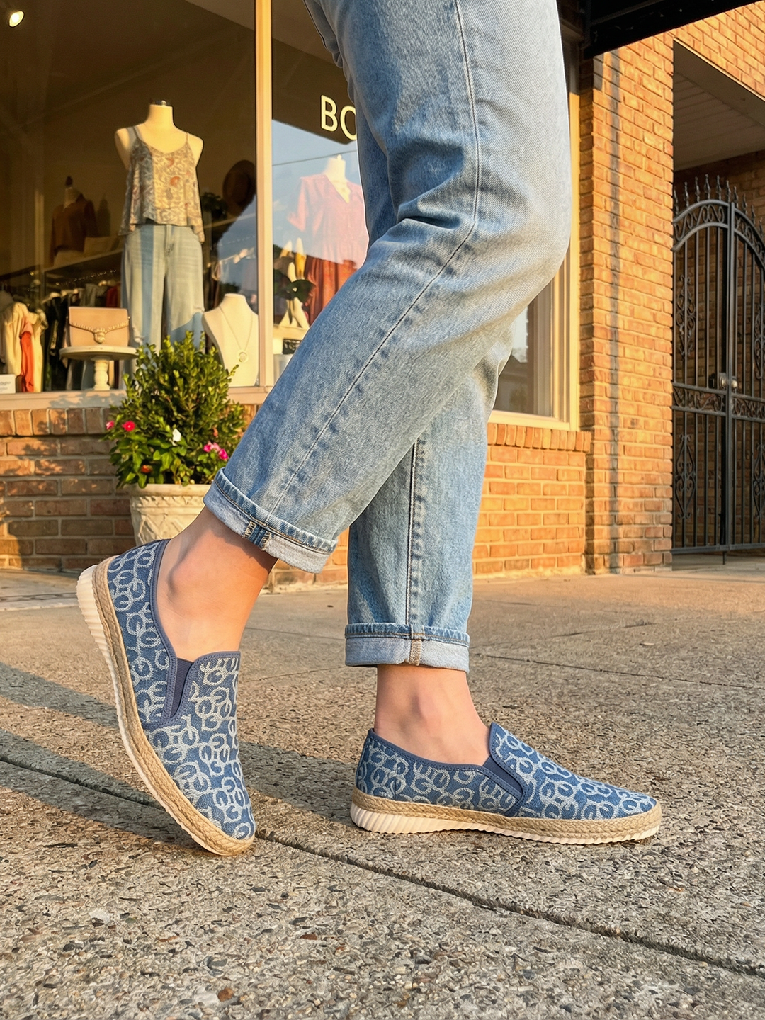 bugatti Colville Blue Comfort Slip-Ons casual shoes featuring a textured blue patterned upper and jute trim, being worn with jeans.