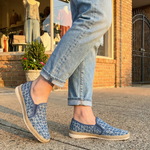 bugatti Colville Blue Comfort Slip-Ons casual shoes featuring a textured blue patterned upper and jute trim, being worn with jeans.