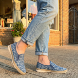 bugatti Colville Blue Comfort Slip-Ons casual shoes featuring a textured blue patterned upper and jute trim, being worn with jeans.