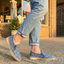 bugatti Colville Blue Comfort Slip-Ons casual shoes featuring a textured blue patterned upper and jute trim, being worn with jeans.