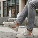 Lifestyle view of bugatti Fiero grey sneakers featuring a breathable textile upper with orange and gray accents.
