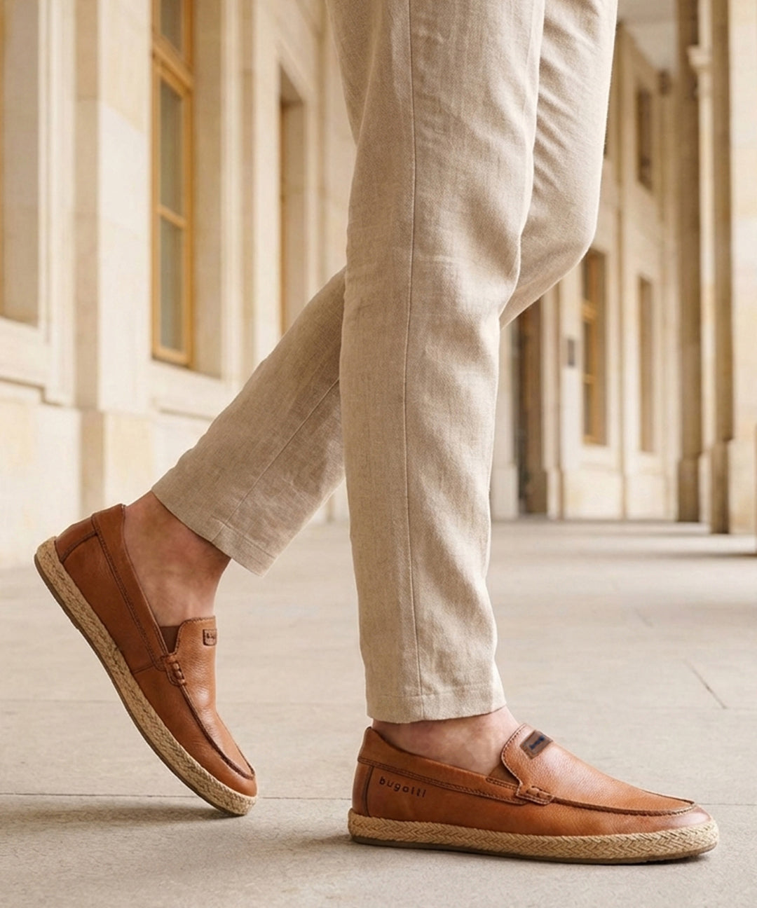 Lifestyle shot of a man wearing bugatti Spendril Cognac leather slip-on shoes with light brown linen pants.