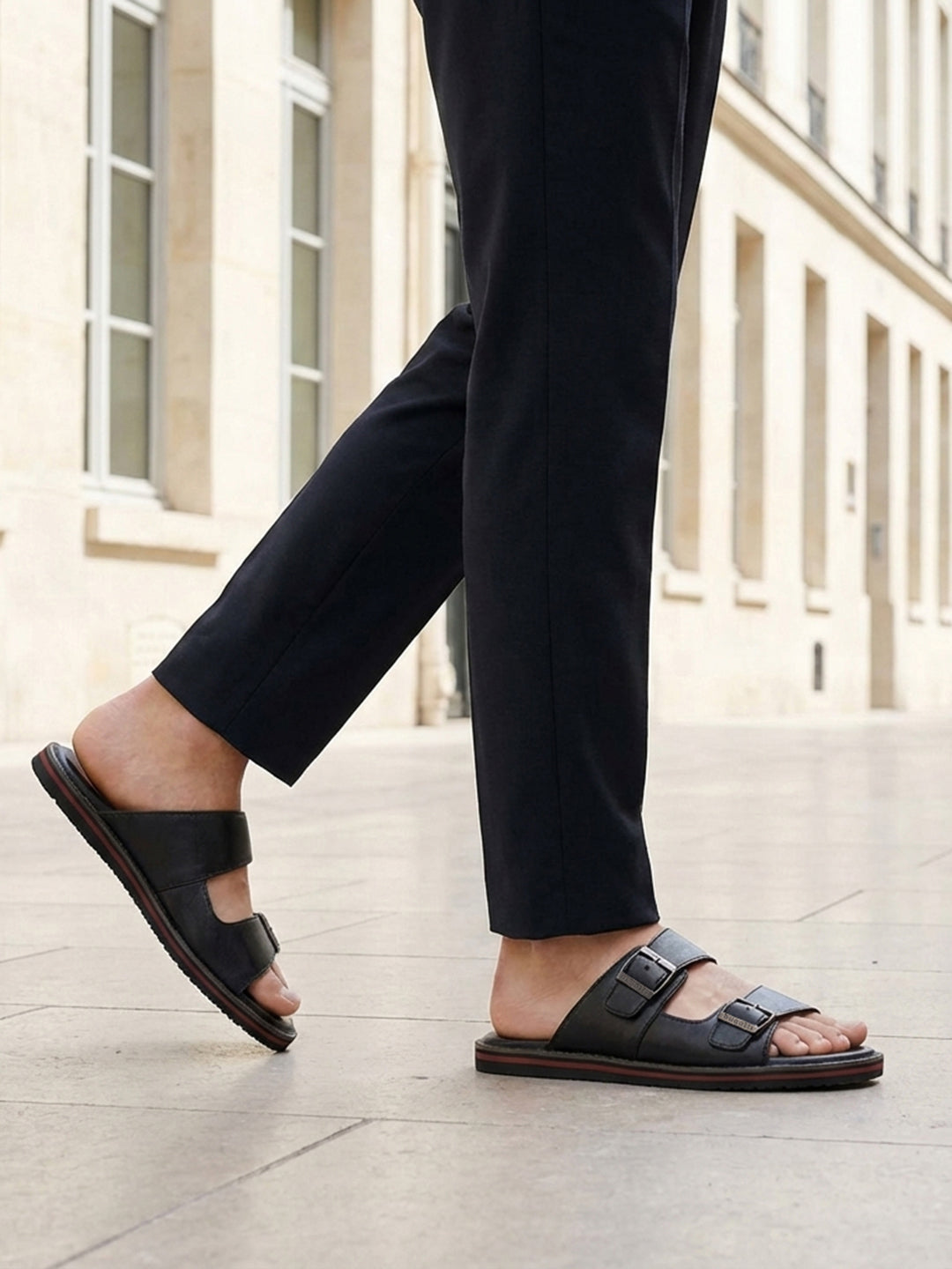 bugatti Cobie black leather sandals with adjustable buckle straps and red stripe on the sole.
