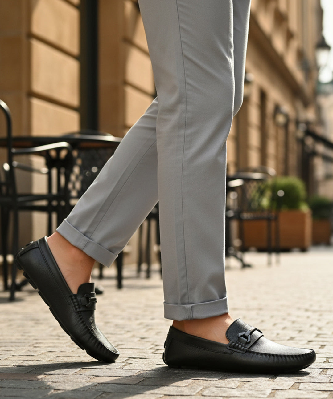 bugatti Olexa dark green leather slip-on shoe with decorative strap detail, worn with gray pants.
