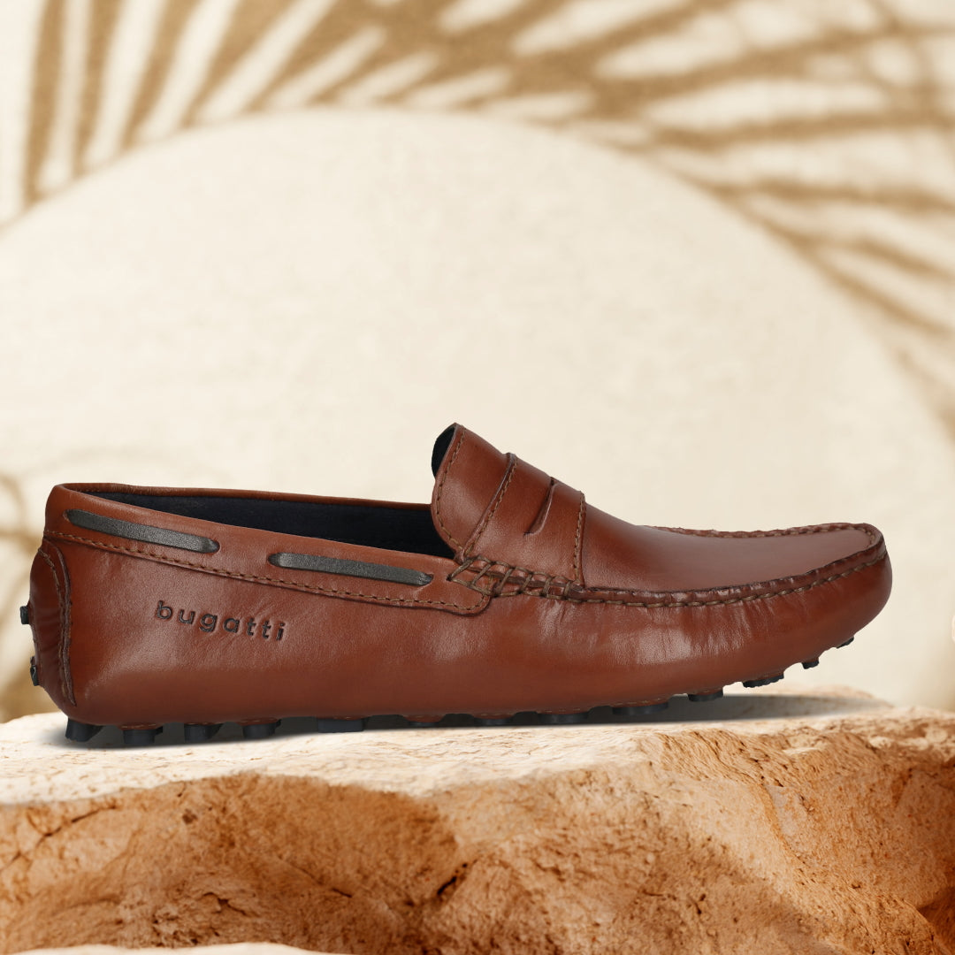 Men's Bugatti drivers cognac leather shoes with a round toe and apron toe , a tpr outsole.