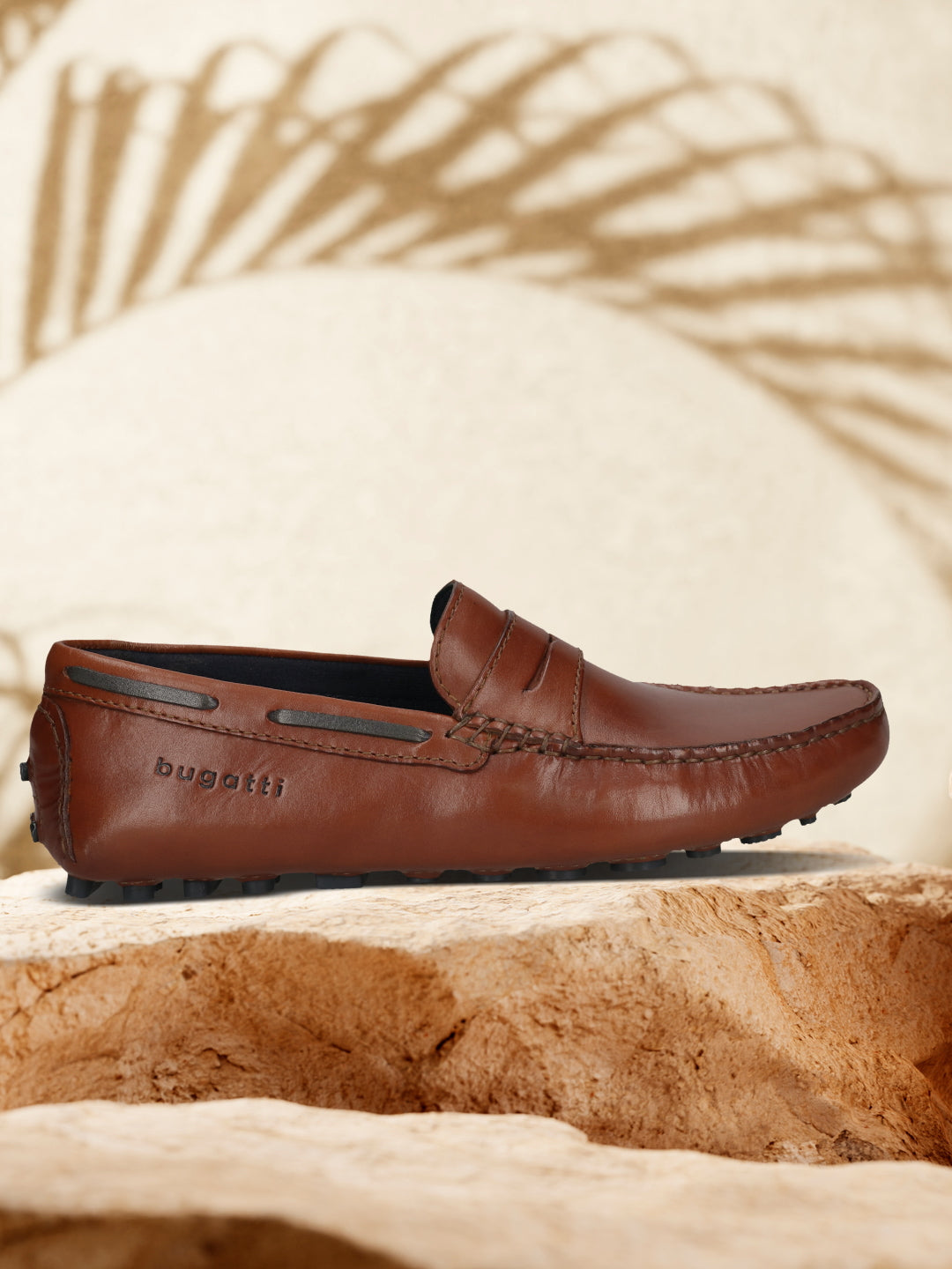 Men's Bugatti drivers cognac leather shoes with a round toe and apron toe , a tpr outsole.