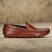 Men's Bugatti drivers cognac leather shoes with a round toe and apron toe , a tpr outsole.