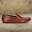 Men's Bugatti drivers cognac leather shoes with a round toe and apron toe , a tpr outsole.
