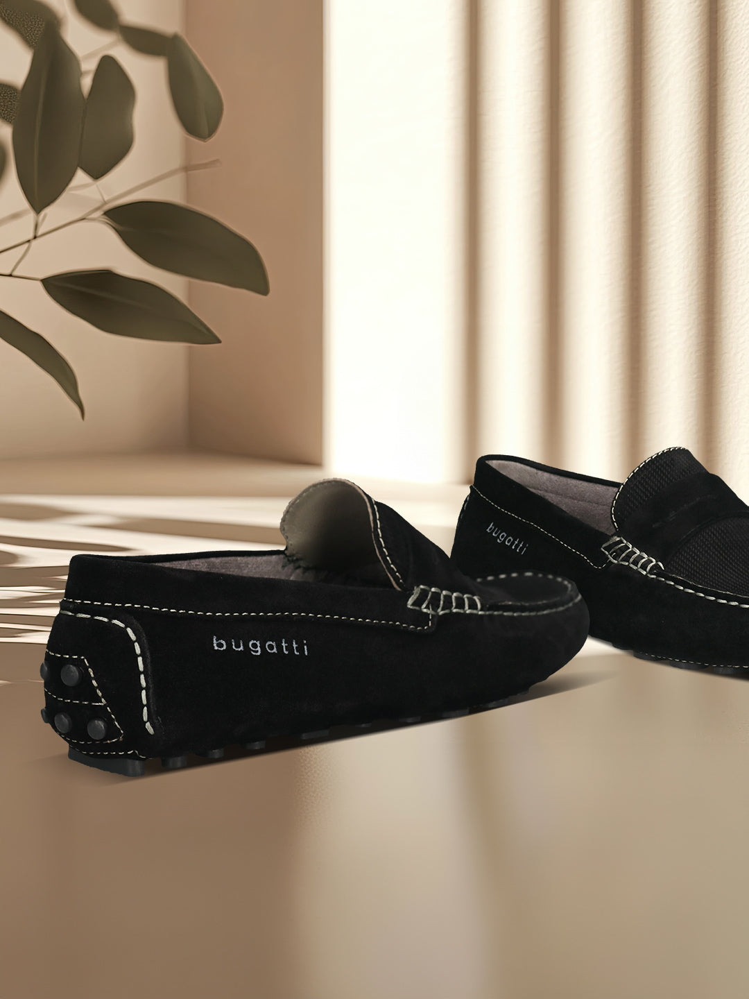 Men's Bugatti drivers black leather shoes with a round toe and apron toe , a tpr outsole.