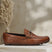 A cognac Men's bugatti Drivers featuring a round toe apron toe, zero heels heel. Made from premium genuine leather with a durable rubber outsole, this slip-on design offers both style and comfort.