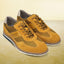 A yellow Men's bugatti Casuals Shoes featuring a round toe wing tip, zero heels heel, and a wide fit. Made from premium genuine leather with a durable tr outsole, this laces design offers both style and comfort.