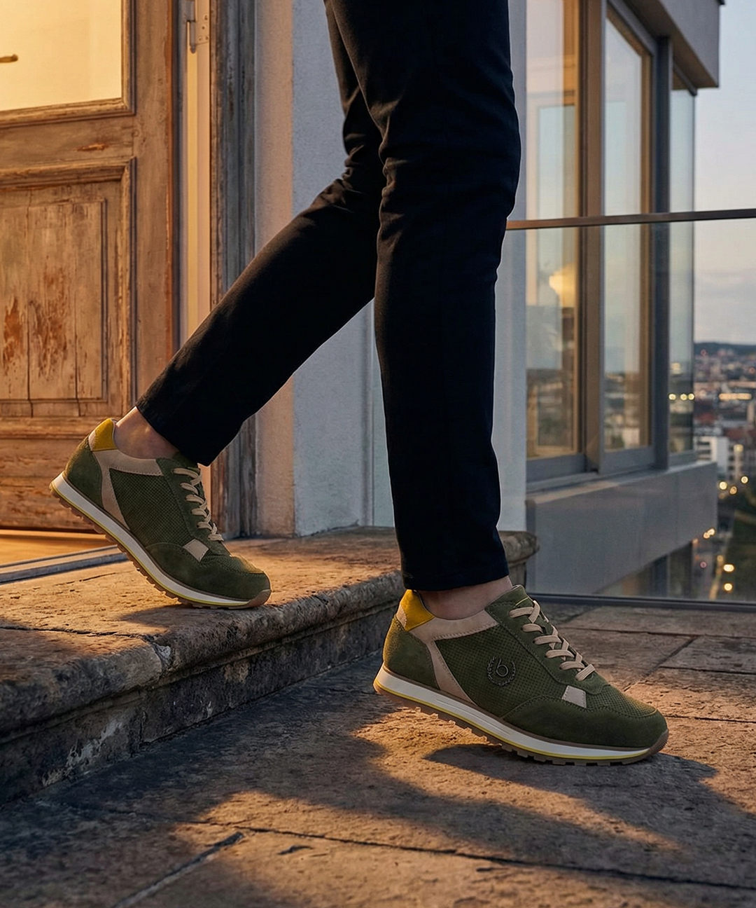 Lifestyle shot of bugatti Garnet Evo dark green leather sneakers with yellow and beige accents.
