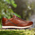 A cognac Men's bugatti Sneakers featuring a round toe plain toe, zero heels heel. Made from premium genuine leather with a durable eva outsole, this laces design offers both style and comfort.